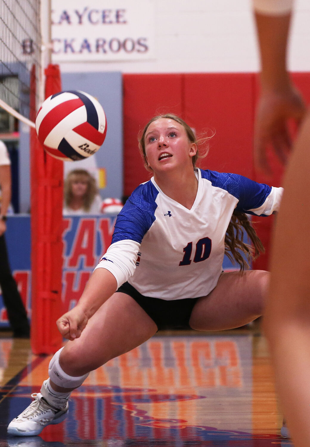 Kaycee High School sophomore Sierra Kilts stretches for a falling ball